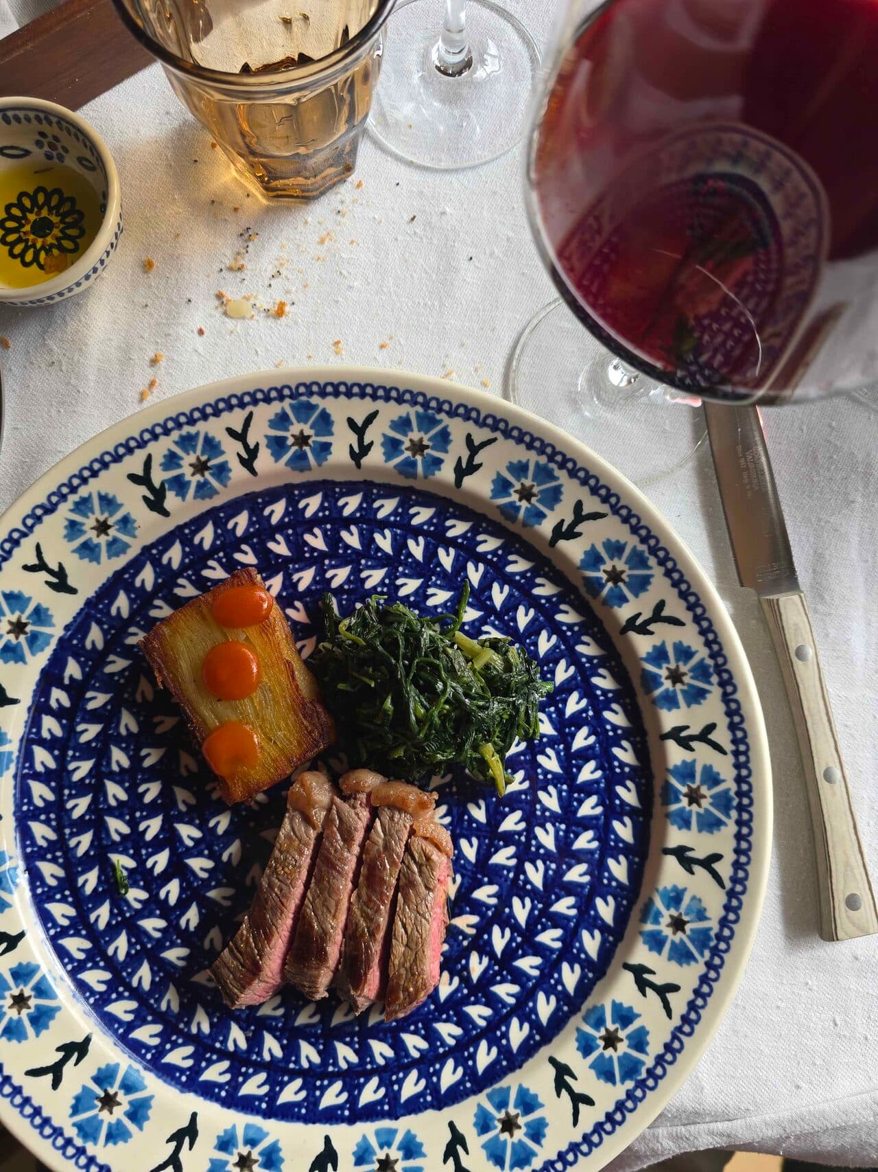 Lunch at Bindella winery — sliced steak with greens and a glass of Vino Nobile Lunch at Bindella winery — sliced steak with greens and a glass of Vino Nobile
